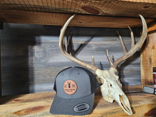 Frigid Forage Trucker Snapback hats with leather patch.     Charcoal/Black
